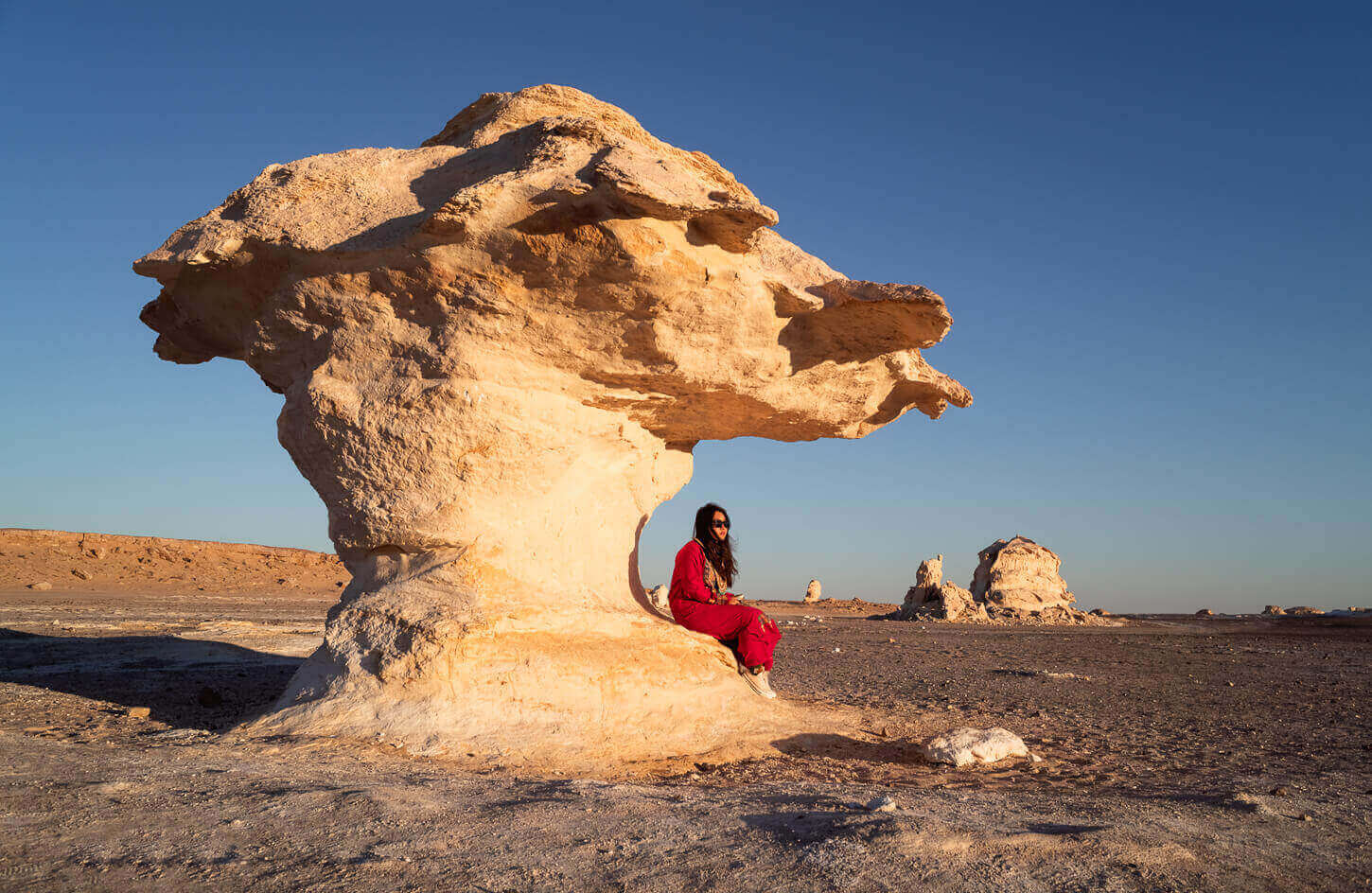 A girl on one of the white dunes of the White Desert