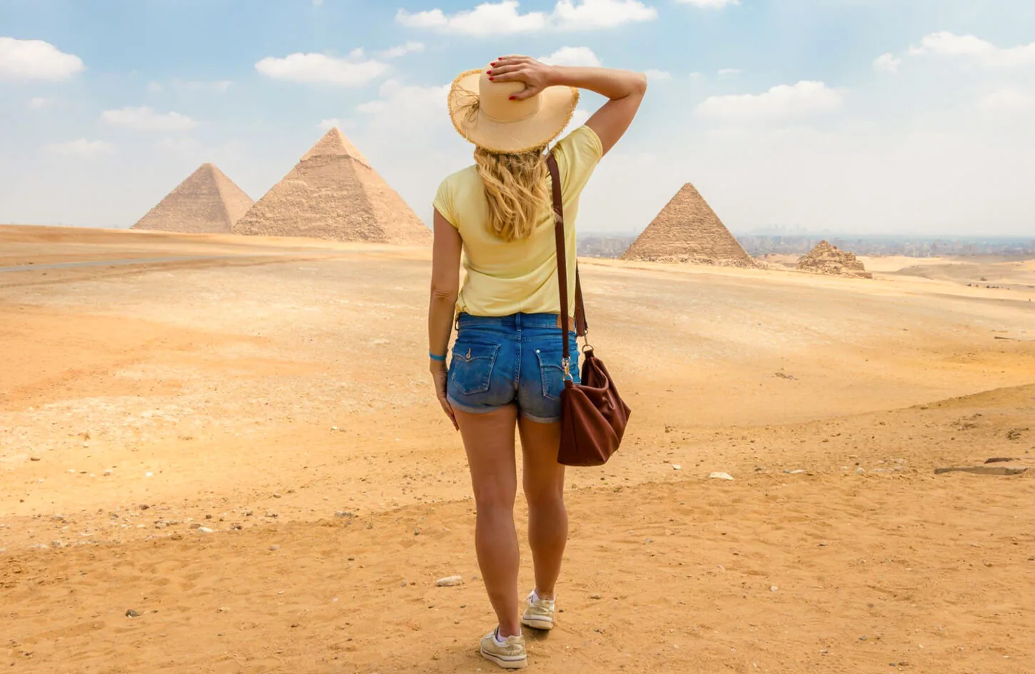 A solo female traveler in front of the pyramids