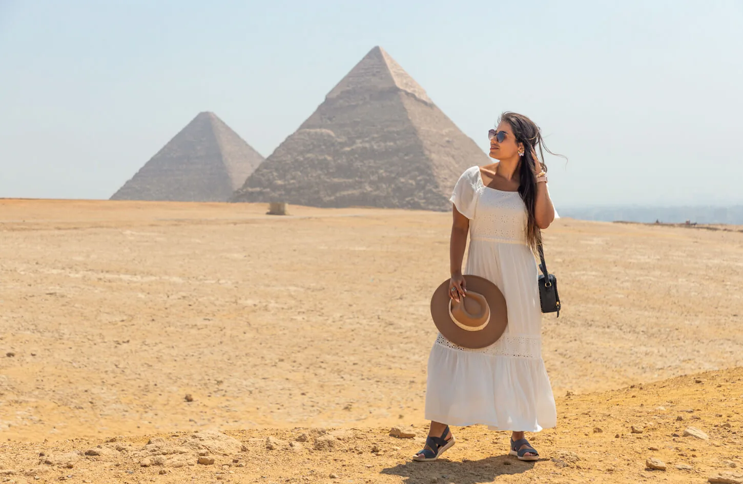 A tourist in front of the pyramids