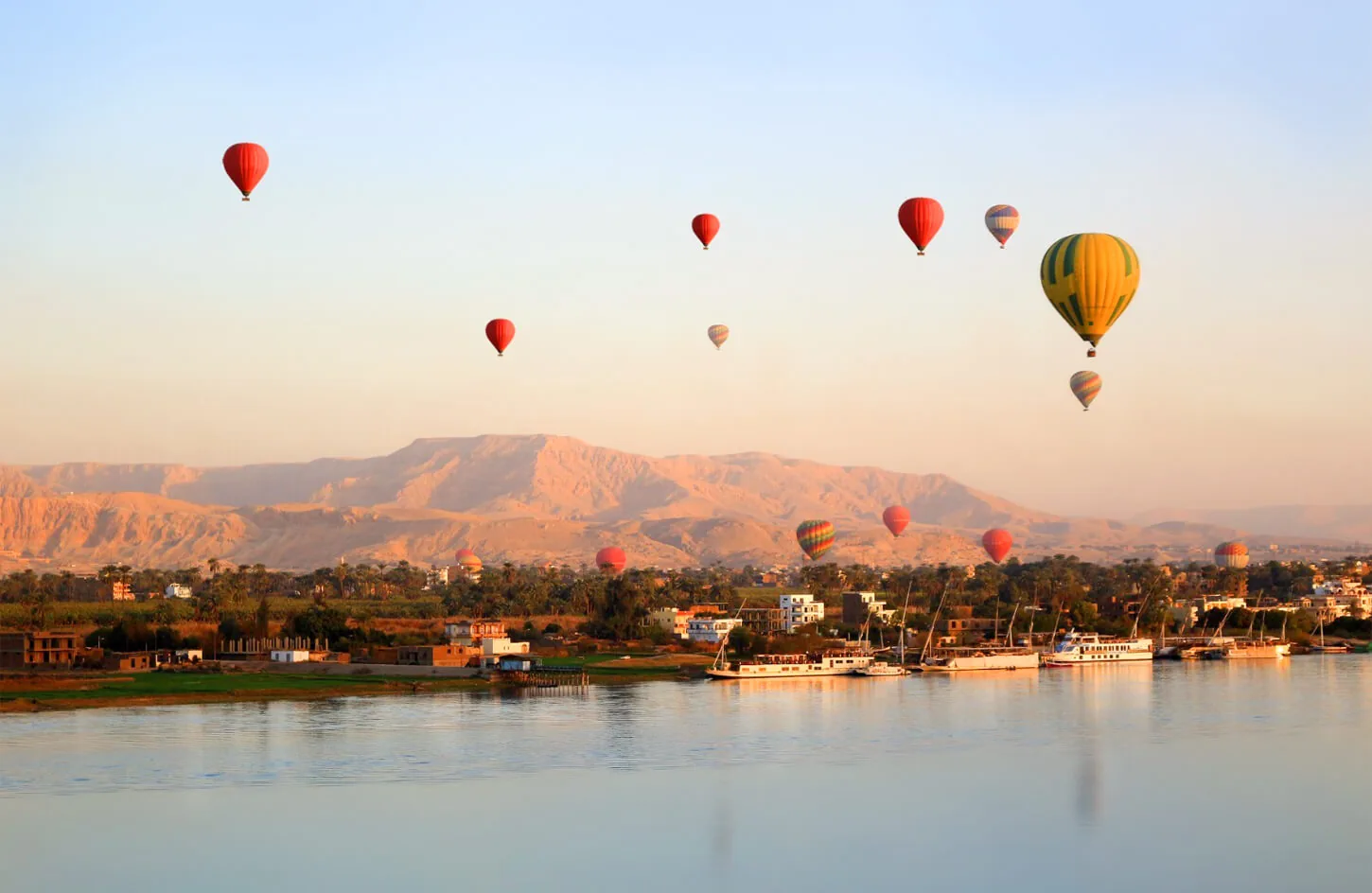 Hot air balloons above the Nile and the west bank of Luxor