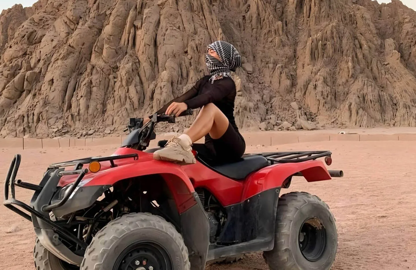 A woman on a quad bike in the marsa alam desert