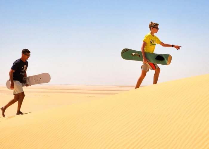 A-wonderful-shot-of-father-and-son-while-practicing-sandboarding-in-Fayoum
